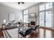 Light-filled living room boasts a fireplace, hardwood floors, neutral tones, and French doors leading to an outdoor space at 2274 Finchley Rd, Carmel, IN 46032