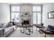 Bright living room featuring high ceilings, a fireplace, hardwood floors, neutral tones, and stylish furnishings at 2274 Finchley Rd, Carmel, IN 46032