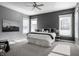 Spacious bedroom with accent wall, plush carpeting, natural light, and a ceiling fan at 2274 Finchley Rd, Carmel, IN 46032