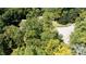 Aerial view of a property surrounded by mature trees and a paved driveway at 2688 S Oscar Ct, Morgantown, IN 46160