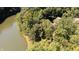 Aerial view highlighting a home by the waters edge, surrounded by lush trees at 2688 S Oscar Ct, Morgantown, IN 46160