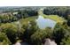 Aerial view of a lakefront property offering serene waterfront views surrounded by trees at 2688 S Oscar Ct, Morgantown, IN 46160