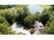 Aerial view showcasing the house, yard and access to a scenic lake at 2688 S Oscar Ct, Morgantown, IN 46160