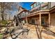 Spacious backyard featuring a brick patio, stone steps, mature trees and ample seating at 2688 S Oscar Ct, Morgantown, IN 46160
