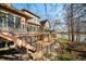 Backyard featuring a multi-level deck leading to the pond; landscaping with brick retaining wall at 2688 S Oscar Ct, Morgantown, IN 46160