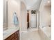 Bright bathroom features a soaking tub, tiled floor and views through arched doorway at 2688 S Oscar Ct, Morgantown, IN 46160