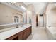 Bright bathroom features a double vanity with wood cabinets and a tiled floor at 2688 S Oscar Ct, Morgantown, IN 46160