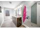 This modern bathroom includes a double vanity, neutral tile flooring, and a glass-enclosed shower at 2688 S Oscar Ct, Morgantown, IN 46160