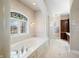 Bathroom features a large soaking tub with tile surround and stained-glass window at 2688 S Oscar Ct, Morgantown, IN 46160