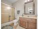 Bathroom featuring sliding shower doors, standard toilet, vanity and green accent rug at 2688 S Oscar Ct, Morgantown, IN 46160