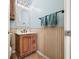 Charming powder room featuring a wood vanity, decorative mirror, and beadboard paneling at 2688 S Oscar Ct, Morgantown, IN 46160