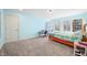 Bright bedroom with blue walls, a corner desk, a large sunny window, and neutral carpet at 2688 S Oscar Ct, Morgantown, IN 46160