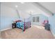 This bedroom features blue walls, an elegant chandelier, and large windows that let in plenty of natural light at 2688 S Oscar Ct, Morgantown, IN 46160