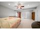 Spacious bedroom with large area rug, ceiling fan, built-in dresser, and plenty of natural light at 2688 S Oscar Ct, Morgantown, IN 46160