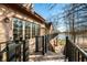 Spacious deck with black metal railing features oversized windows and lake views at 2688 S Oscar Ct, Morgantown, IN 46160