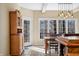 Bright dining room features natural light from large windows and a charming wooden hutch at 2688 S Oscar Ct, Morgantown, IN 46160