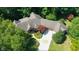 Elegant home displays mature foliage, beautifully landscaped gardens, and an expansive paved driveway at 2688 S Oscar Ct, Morgantown, IN 46160