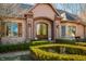 A detailed view of the home's front entrance with its double doors, manicured shrubs, and brick facade at 2688 S Oscar Ct, Morgantown, IN 46160
