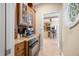 Hallway leading to a kitchen featuring granite counters, a built-in oven, and access to additional spaces at 2688 S Oscar Ct, Morgantown, IN 46160