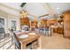 Open concept kitchen and dining area with wooden cabinetry, island seating, and rustic beam accents at 2688 S Oscar Ct, Morgantown, IN 46160