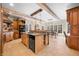 A traditional style kitchen with stone floors, wood cabinets, stainless steel appliances, and a breakfast bar at 2688 S Oscar Ct, Morgantown, IN 46160