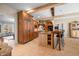 A spacious kitchen with an eat-in island, custom cabinets, stainless steel appliances, and stone floors at 2688 S Oscar Ct, Morgantown, IN 46160