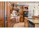 The kitchen boasts custom cabinets, tiled backsplash, modern appliances, and an eat-in island with a granite countertop at 2688 S Oscar Ct, Morgantown, IN 46160