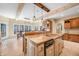 Spacious kitchen features an island with granite countertop, wood beams and tile flooring at 2688 S Oscar Ct, Morgantown, IN 46160