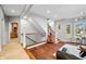An open-concept living room with hardwood floors, a staircase, and lots of natural light at 2688 S Oscar Ct, Morgantown, IN 46160
