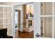 Through open doors, a view of the living room fireplace is seen from the kitchen doorway at 2688 S Oscar Ct, Morgantown, IN 46160