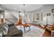 Bright living room boasts hardwood floors, statement lighting, stairs, and large windows overlooking the front yard at 2688 S Oscar Ct, Morgantown, IN 46160