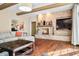 Bright living room with a brick fireplace and a doorway that opens to a music room with a piano at 2688 S Oscar Ct, Morgantown, IN 46160