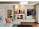 Open living room featuring a brick fireplace and a built-in TV, offering a comfortable and stylish space at 2688 S Oscar Ct, Morgantown, IN 46160