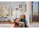 A cozy, sunlit living room featuring a comfortable leather chair, modern lighting, and a view of the front entrance at 2688 S Oscar Ct, Morgantown, IN 46160