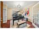 A beautifully decorated living room features a grand piano, hardwood floors and a bright window at 2688 S Oscar Ct, Morgantown, IN 46160