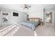 Bright main bedroom features a ceiling fan, a tv, and large windows at 2688 S Oscar Ct, Morgantown, IN 46160