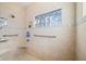 Tiled shower features a glass block window, grab bars, and adjustable shower head at 2688 S Oscar Ct, Morgantown, IN 46160