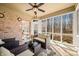 Charming sunroom with brick wall, wicker furniture, and ceiling fan, blending indoor and outdoor living at 2688 S Oscar Ct, Morgantown, IN 46160