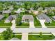 A neighborhood aerial view showcasing a house with a well-manicured lawn and mature trees at 286 S Woodridge Dr, Pittsboro, IN 46167