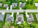 Aerial view of a home surrounded by mature trees, a swimming pool, and well-maintained lawns at 286 S Woodridge Dr, Pittsboro, IN 46167
