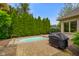 Private backyard with in-ground hot tub, lush landscaping, and grill at 286 S Woodridge Dr, Pittsboro, IN 46167