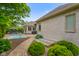 A backyard with a hot tub, patio furniture, brick walkways, mature trees and a view of the house at 286 S Woodridge Dr, Pittsboro, IN 46167