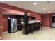 Finished basement features a wet bar with seating, stainless steel appliances, and attractive flooring at 286 S Woodridge Dr, Pittsboro, IN 46167