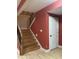Finished basement stairs feature hardwood treads, black metal railing, and access to the finished basement at 286 S Woodridge Dr, Pittsboro, IN 46167