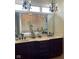 Elegant bathroom with dual sinks, marble countertops, dark wood cabinetry, and stylish chandelier lighting at 286 S Woodridge Dr, Pittsboro, IN 46167
