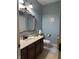 Stylish bathroom featuring a large decorative mirror, marble countertop vanity, and a modern toilet at 286 S Woodridge Dr, Pittsboro, IN 46167