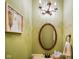 Charming powder room features a decorative mirror, light fixture, and elegant fixtures at 286 S Woodridge Dr, Pittsboro, IN 46167