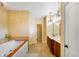 This spacious bathroom features a large soaking tub, chandelier, and double vanity at 286 S Woodridge Dr, Pittsboro, IN 46167