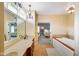 This spacious bathroom features a large soaking tub, chandelier, and double vanity at 286 S Woodridge Dr, Pittsboro, IN 46167