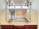 This double vanity reflects a soaking tub and chandelier-lit bathroom at 286 S Woodridge Dr, Pittsboro, IN 46167